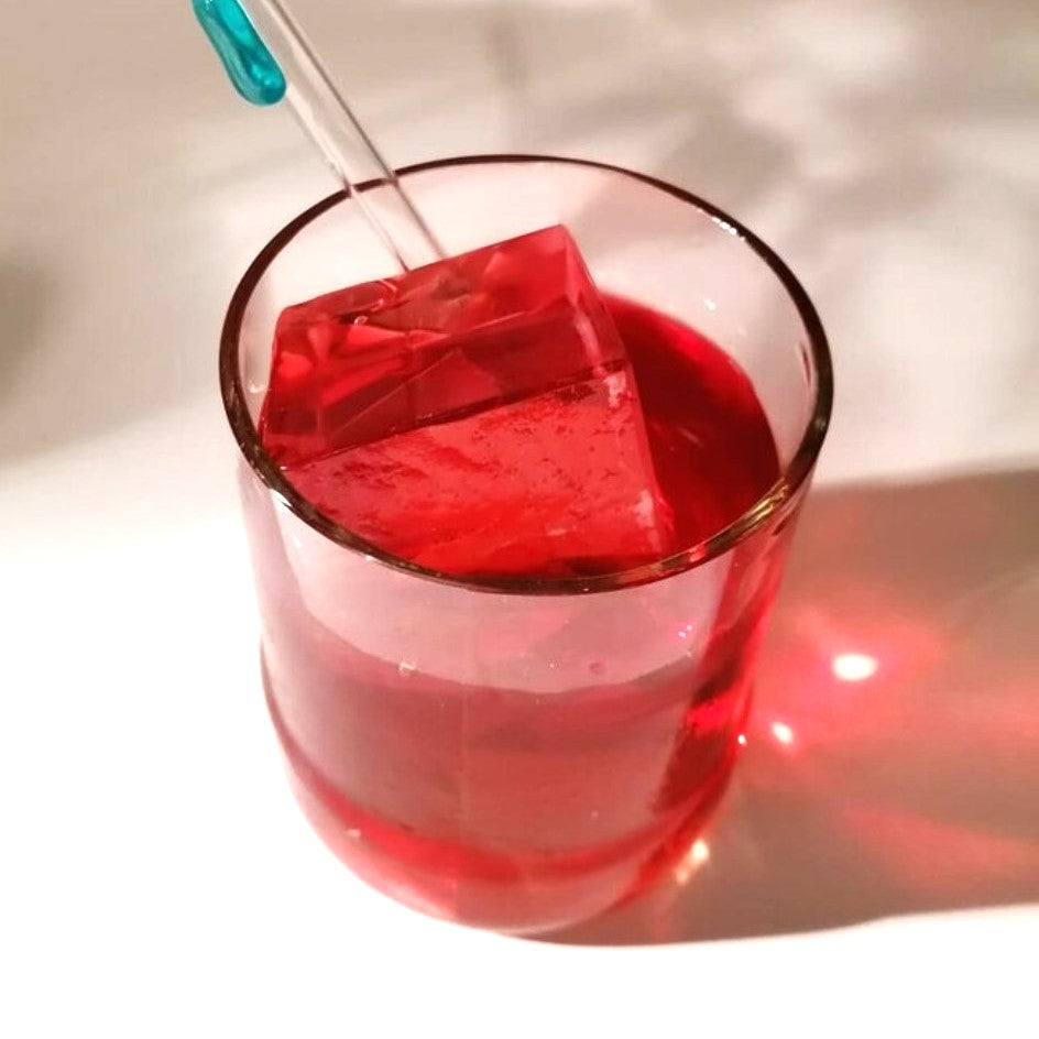 recycled glass tumbler with red cocktail and ice